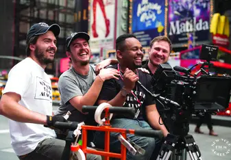 Man holds camera in Times Square