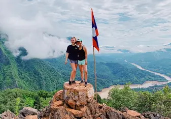 Two volunteers standing on a rock