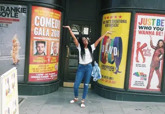 Kagiso J. in front of signs
