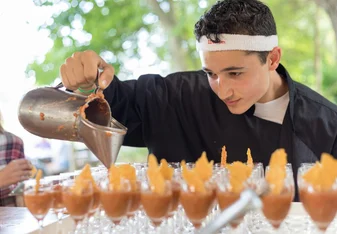 a student pours out something delicious in our culinary class