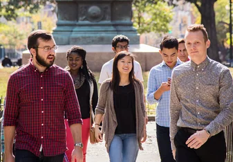 A group of students and a staff member walking outside