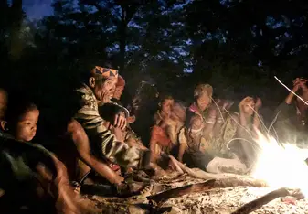 San Bushmen sitting around the fire at a Healing dance event