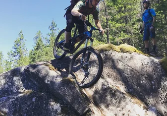 Student learning bike skills on slick rock