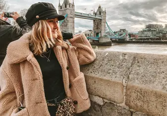 Woman looking at the Tower Bridge in London, England.