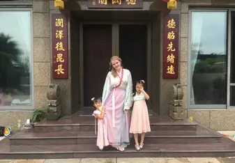 Lena Vivi in traditional gown with host family