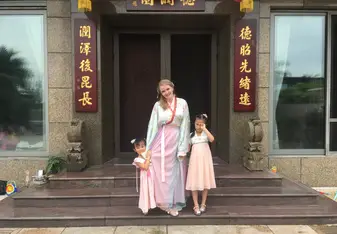 Lena Vivi in traditional gown with host family