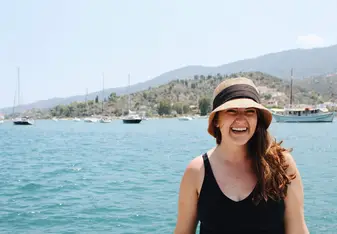 Student smiling in front of water