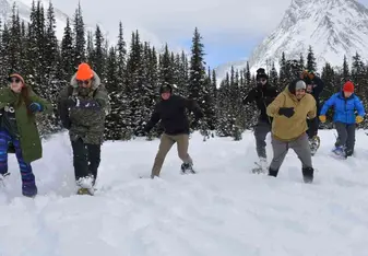 Youth running on snowshoes towards camera