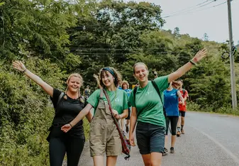 Emily K with her volunteer group walking on a street in Thailand