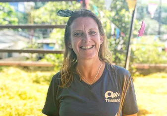 Vanessa Rees with a hair bow headband and blue GVI Thailand shirt smiling