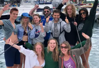 Vanessa Rees with a group on a boat smiling