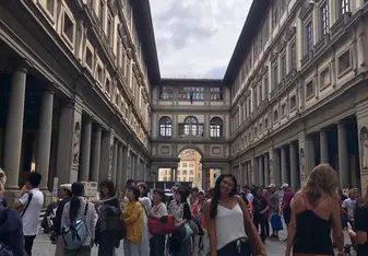 Marissa Jansen standing in a square in Spain with a crowd of people behind her.