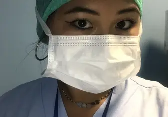 Marissa Jansen in scrubs wearing a surgical mask