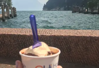 Marissa Jansen holding gelato ice cream out with the sea in the background