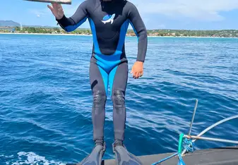 Joma Dix about to dive in the ocean with wetsuit and snorkel gear