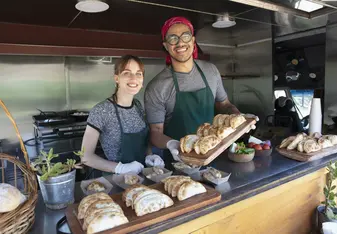 two students making empanadas