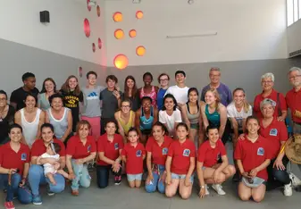 Brittany Shelley with a group of students all wearing a red shirt