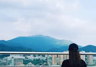 Shannon facing a mountain in South Korea