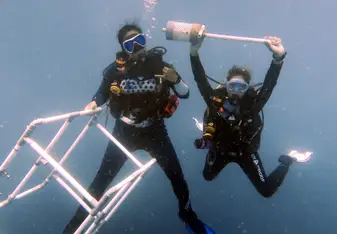 Helen Wu diving with a diving buddy