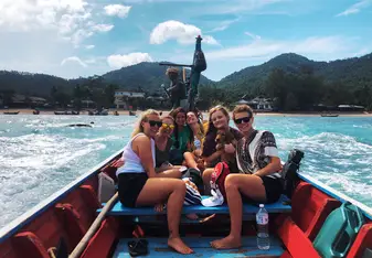 Samantha P on a boat in Thailand with other gap year students