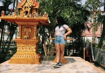 Kirsty Davids standing in front of a shrine in Thailand