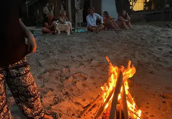 Natasha Kelleher on the beach with a bonfire