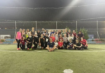 Students and local jiran posing for a photo after playing a pickup game of soccer