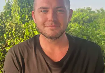 Matt Craig wearing a black GVI shirt with a green logo