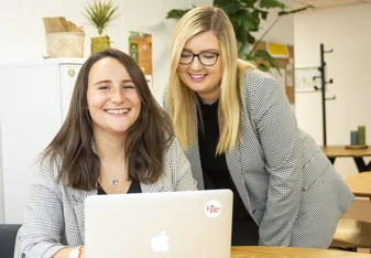 Two interns working at the office