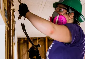 volunteer gutting interior of home