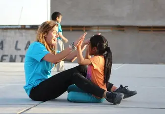 HOOP volunteer playing with student