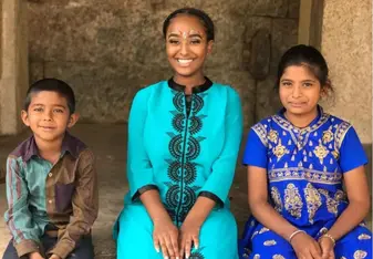 group of school children with study abroad student in India