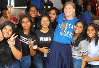 Teacher socialising with students at an event