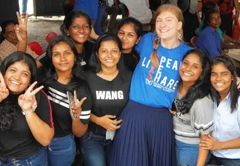 Teacher socialising with students at an event