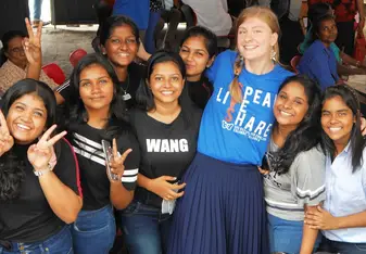 Teacher socialising with students at an event