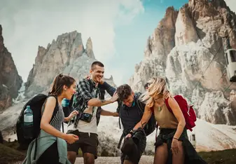 Friends laughing atop mountains 