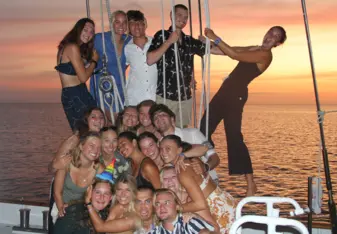 Group of students smiling on a boat