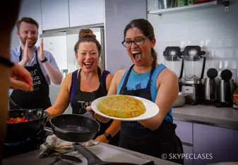 A proud student after cooking a Spanish dish