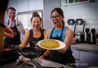 A proud student after cooking a Spanish dish