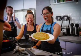 A proud student after cooking a Spanish dish