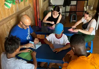 people sitting around table doing a craft