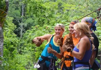 Students participating in a Zip Line Course and the rain forest of Belize