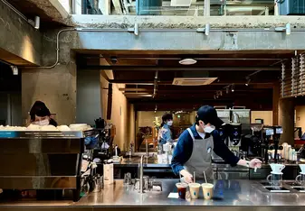 A man works at a cafe.