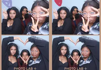 A collage of photo booth strips featuring three friends posing together against a light blue background. They are wearing playful headbands with animal ears and making various fun and expressive gestures. The photos show them making heart shapes with their hands, peace signs, and playful faces. Some of the photos have cute doodles like hearts, stars, and speech bubbles added to them. The friends are wearing casual outfits and appear to be having a great time, capturing the joy and spontaneity of their momen