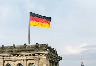 A German flag on top of a tall building