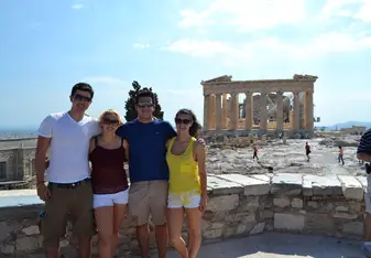 Students smiling in front of the Parthenon