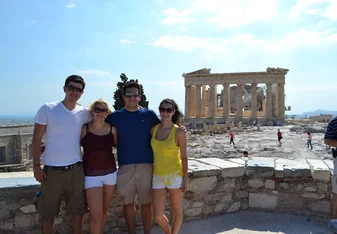 Students smiling in front of the Parthenon