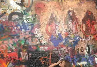 Student looks up at art