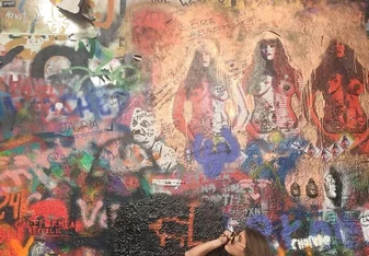 Student looks up at art