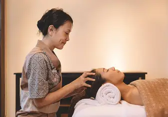 Massage therapist massaging patient's head